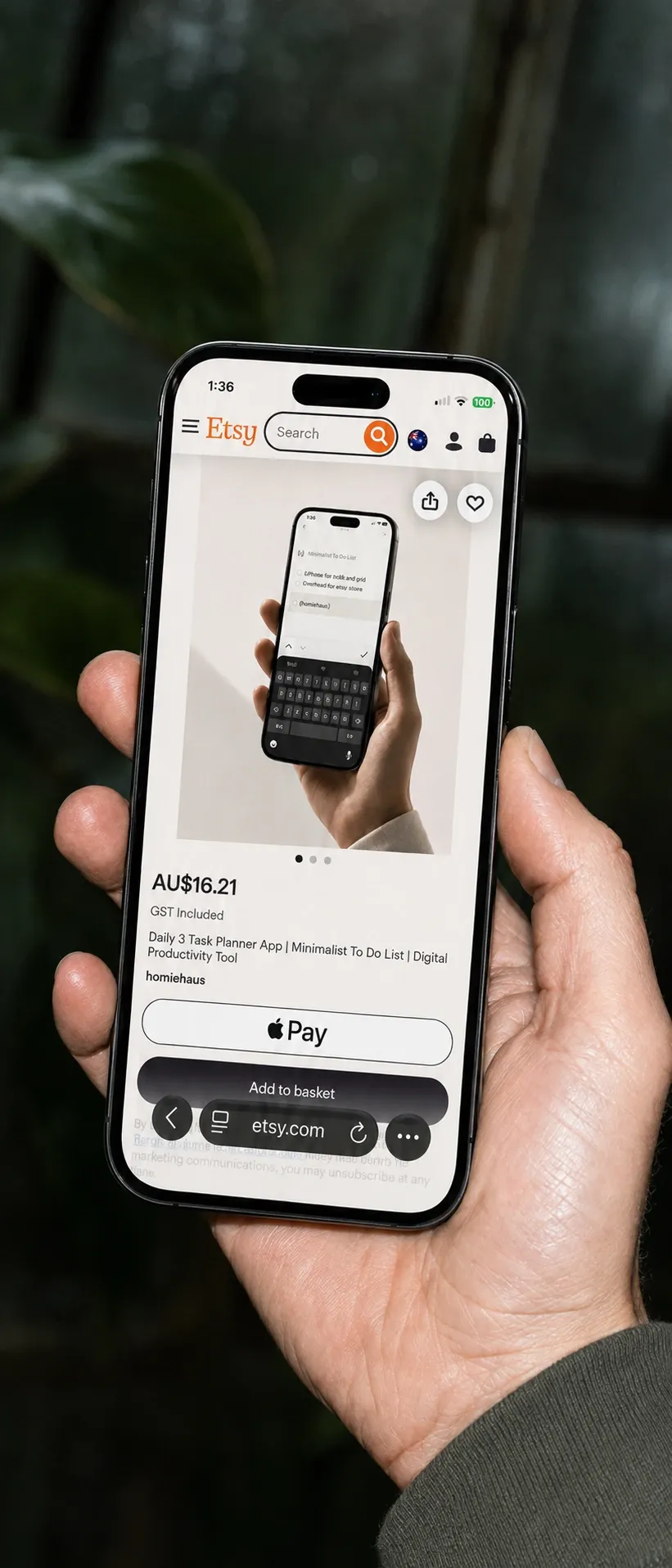 The three planner's Etsy listing open on a phone, held in one hand.